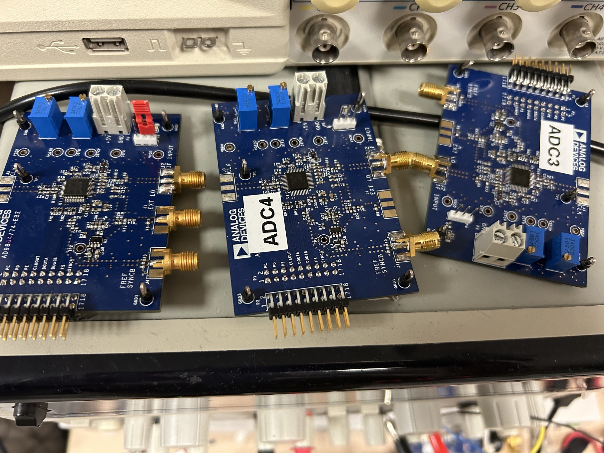 Three blue receiver evaluation boards labeled ADC3, ADC4 and ADC5