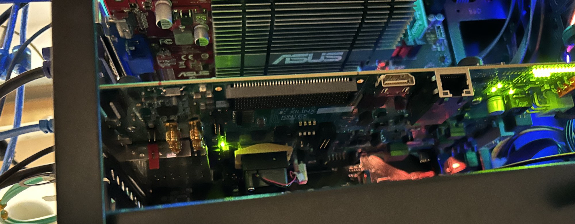 Open computer case with an FPGA card in a PCIe slot