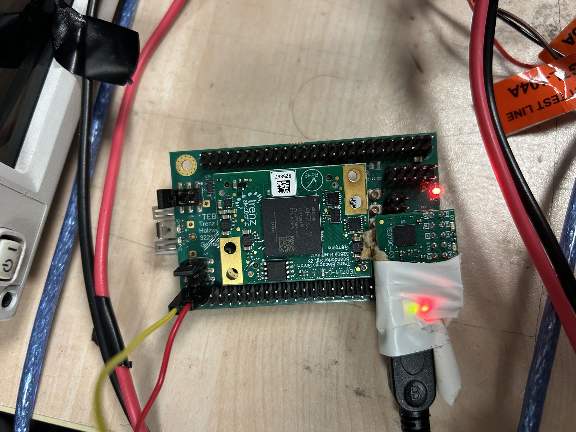 A small FPGA module on a carrier board on the lab bench